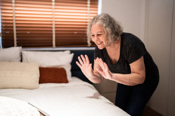istock Senior woman doing a video call at home 1306117686