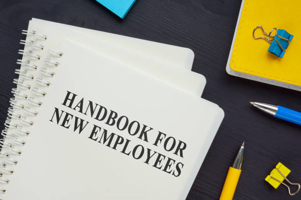 istock Stack of handbook for new employees on the desk. 1306117710