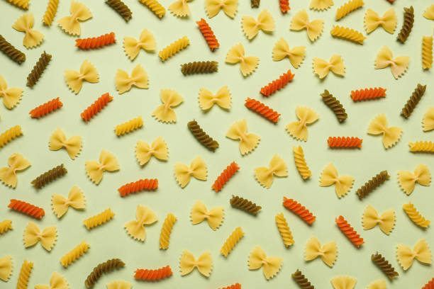 istock Different types of pasta on light green background, flat lay 1306120541