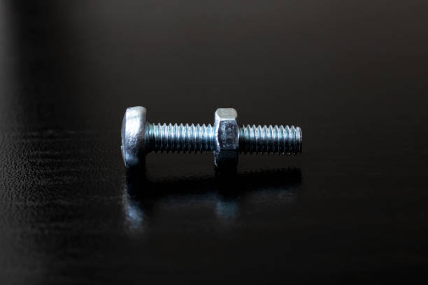 istock Bolt and nut on a wooden background 1306121227