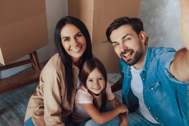 istock Smiley man taking a selfie with his woman and kid 1306122843