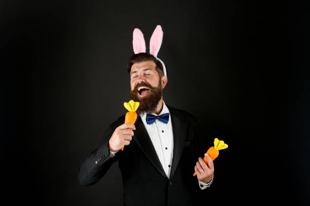 istock This Easter will be filled with music. Easter bunny sing karaoke song. Using carrot for microphone. Businessman pretend singing karaoke. Enjoying karaoke. Music and fun. Karaoke party 1306122871