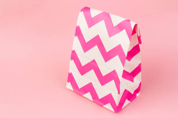 istock Bright gift bag isolated on pink background 1306124394