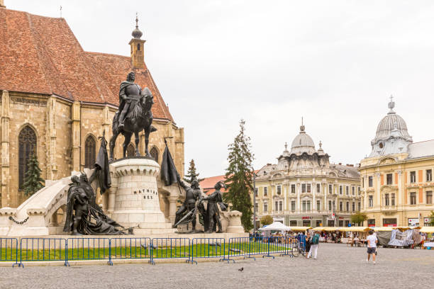 Cluj-Napoca, Romania - July 11, 2013: Matthias Corvinus Monument in front of St. Michael’s is a Catholic Church in the Old Town of Cluj-Napoca in Transylvania, Romania
