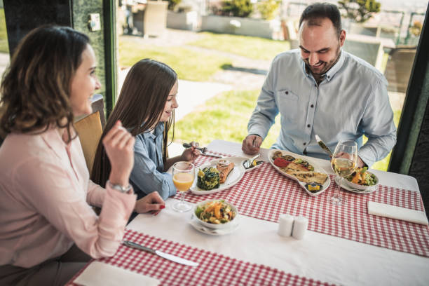 istock family having lunch at a restaurant 1306128296