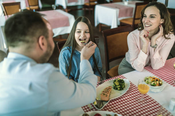 istock family having lunch at a restaurant 1306128574
