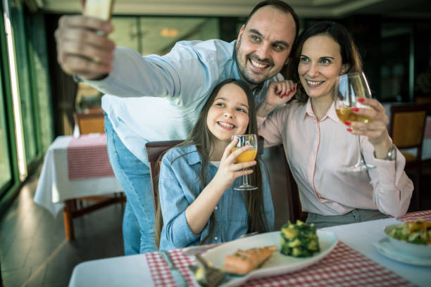 istock family having lunch at a restaurant 1306128962