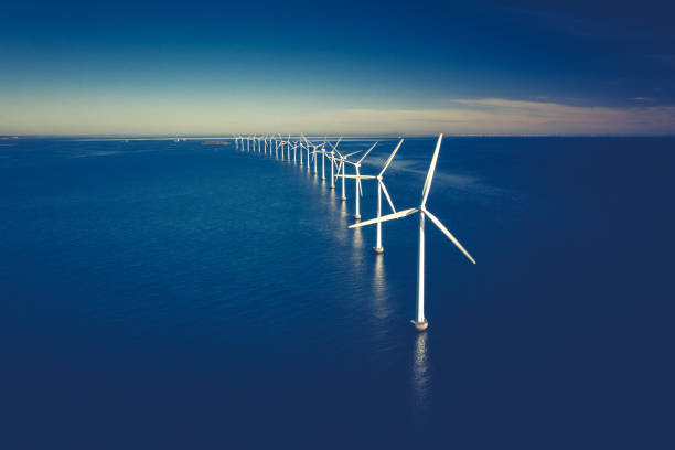 Wind turbines in the ocean stock photo