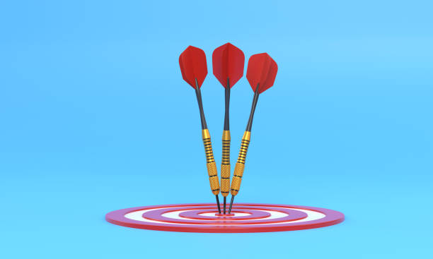 istock Three darts hitting a red target on the center on blue background with copy space 1306130755
