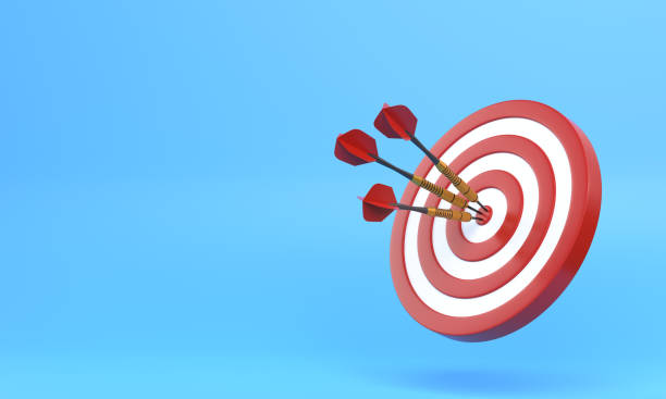 istock Three darts hitting a red target on the center on blue background with copy space 1306130772