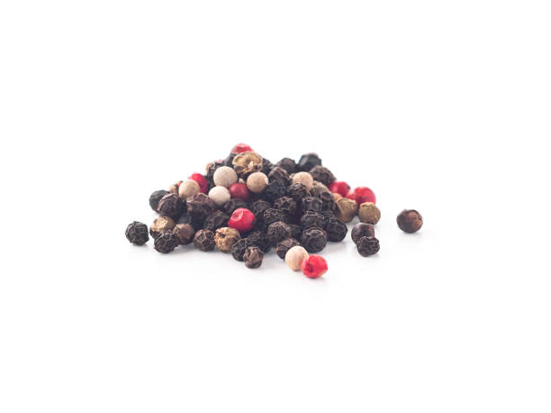 Mix of black, white, green and pink peppercorns Mix of black, white, green and pink peppercorns isolated on white background pink pepper spice ingredient stock pictures, royalty-free photos & images