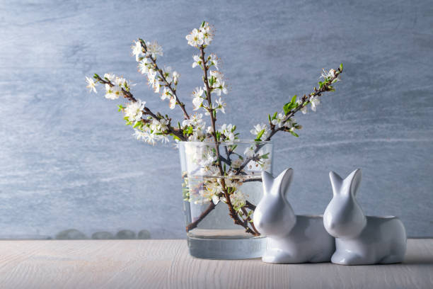 istock Easter celebration concept - Cherry blossoms and Easter bunnies 1306133270