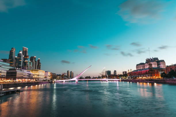 Puerto Madero in Buenos Aires at dusk Buenos Aires, Argentina - November 10th, 2019: Architectural landmark Puente de la Mujer at night in the Puerto Madero commercial district of Buenos Aires, Argentina. puente de la mujer stock pictures, royalty-free photos & images