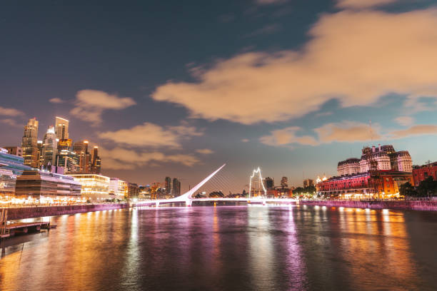 Puerto Madero in Buenos Aires at dusk Buenos Aires, Argentina - November 10th, 2019: Architectural landmark Puente de la Mujer at night in the Puerto Madero commercial district of Buenos Aires, Argentina. puente de la mujer stock pictures, royalty-free photos & images