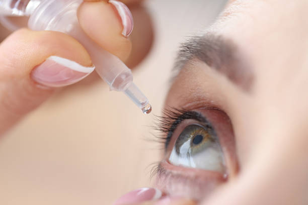 istock Woman drips eye drops into her eyes 1306133578