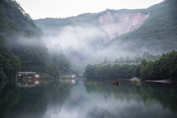 istock Fog at sunrise in a mountain lake 1306133729