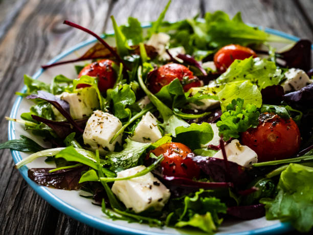 istock Greek salad on wooden table 1306136317