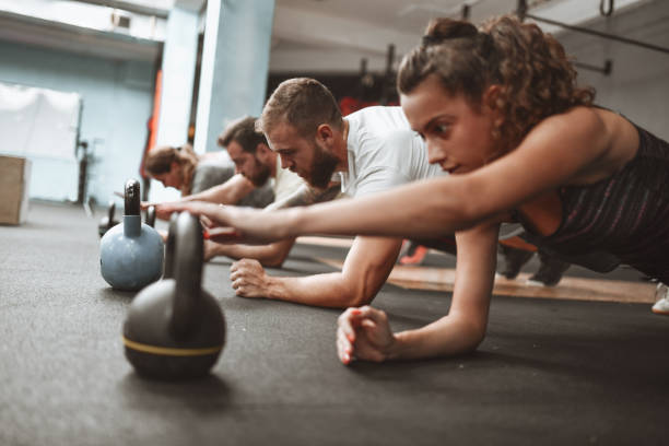 istock Focused Gym Members During Kettlebell Plank In Gym 1306136516