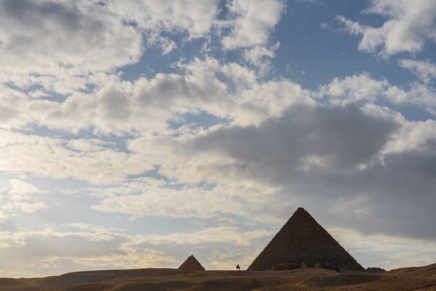 istock Scenic view of Giza pyramids at sunset 1306138542