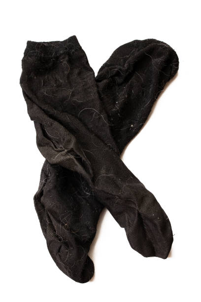 istock Dirty black socks isolates on white background 1306139230
