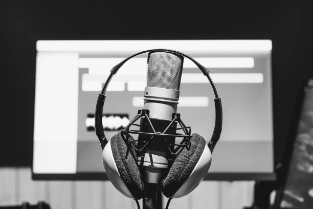 istock microphone and headphone for online live streaming technology or recording on computer monitor background 1306139912