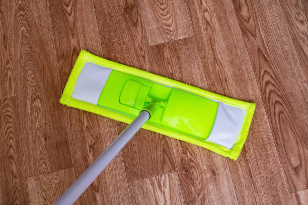 istock Green mop on a wooden floor closeup 1306140304