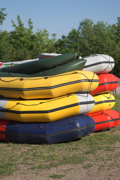 istock Multi-colored rafting boats stacked on top of each other. 1306140394