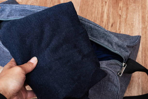 istock Clothes in hand and travel bag closeup 1306140680