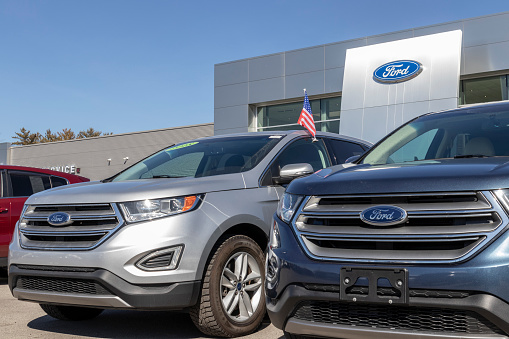 Indianapolis - Circa March 2021: Ford SUV display at a dealership. Ford sells traditional gasoline, electric and hybrid SUV models.