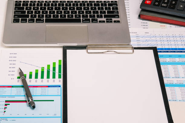 istock Workplace with a financial chart, pen, computer and calculator. Blank sheet of paper for text. Audit, analytics and banking. Accounting in the company 1306143413