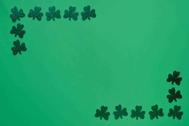 istock Green clovers on green background 1306143462