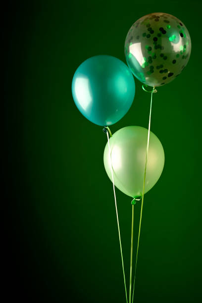 istock Green balloons on dark background 1306143514