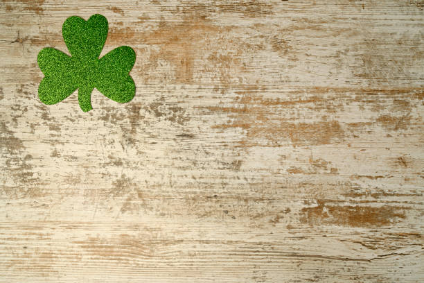 istock Green clover on wood background 1306143524