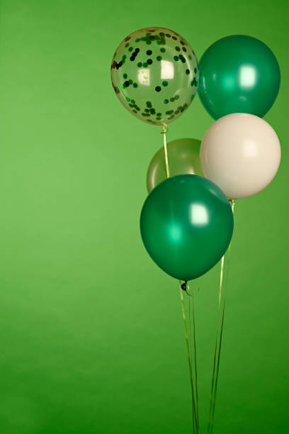 istock Green balloons on green background 1306143691