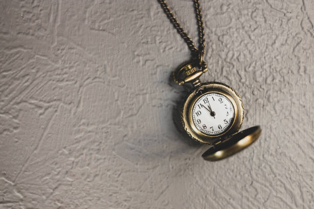 istock Vintage round watch on a chain close-up on a gray background. 1306144010