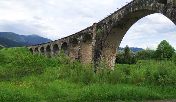 istock Old railway stone bridge or viaduct in mountains 1306144278