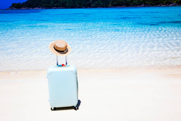 istock Beach Accessories In Suitcase On Beach with white sand background,Travel concept 1306145698