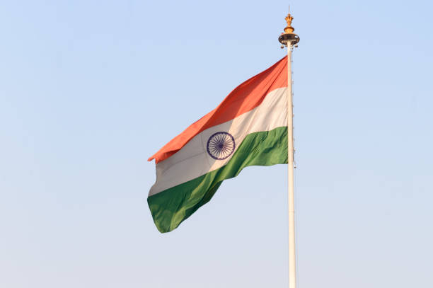 istock Indian flag flying against blue sky background. 1306145998