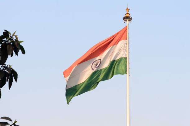 istock Indian flag flying against blue sky background. 1306146002