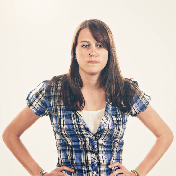 istock Young woman with hands on hips looks irritated and angry 1306146830