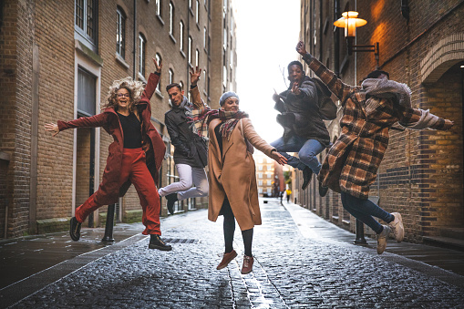 Group of happy friends meets in the street of London.