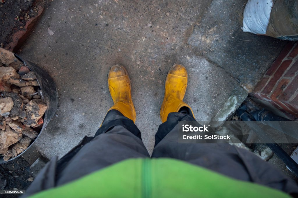 Point of View From a Construction Worker A point of view shot of a construction worker wearing work wear and footwear. Personal Perspective Stock Photo