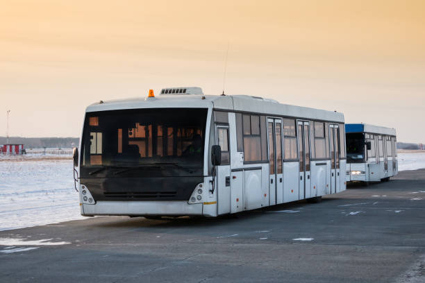 istock Two empty airport shuttle buses in a cold winter evening 1306150659