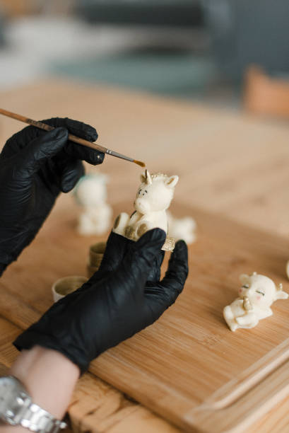 istock a pastry chef in black gloves and a clock makes edible animals 1306152842