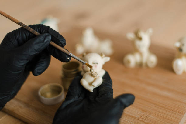 istock confectioner in gloves on the table makes edible animals 1306152916