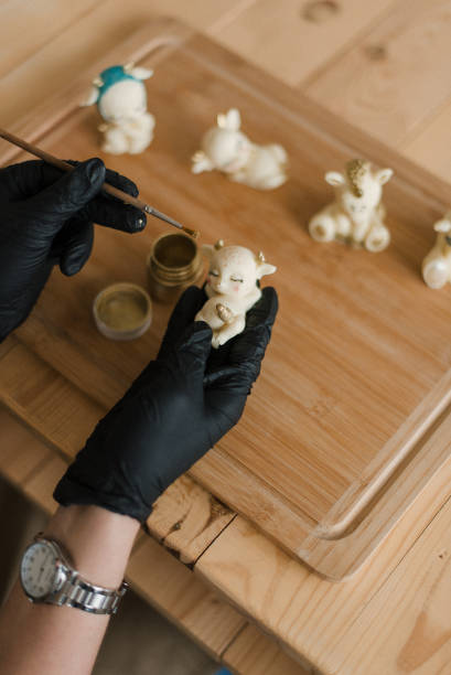 istock a pastry chef in black gloves and a clock makes edible animals 1306152946