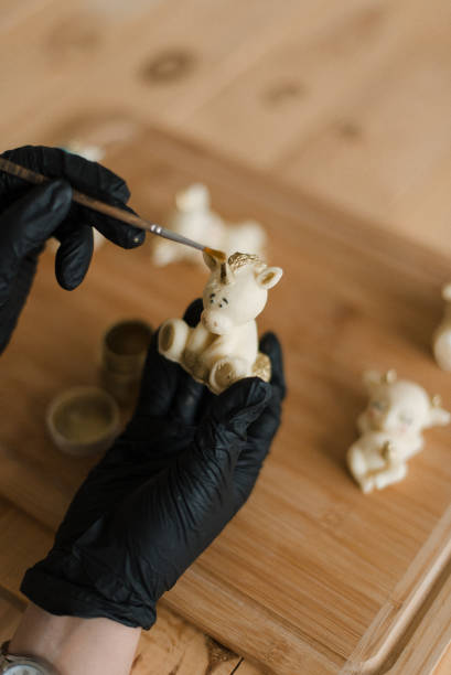 istock confectioner in gloves on the table makes edible animals 1306153024