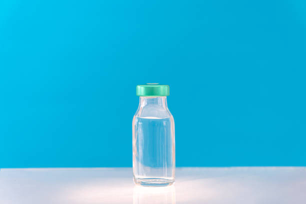 istock Potential trials stage concept on blue background. Close up Vials with sterile needle syringe. Research and Development, Vaccination. 1306153587