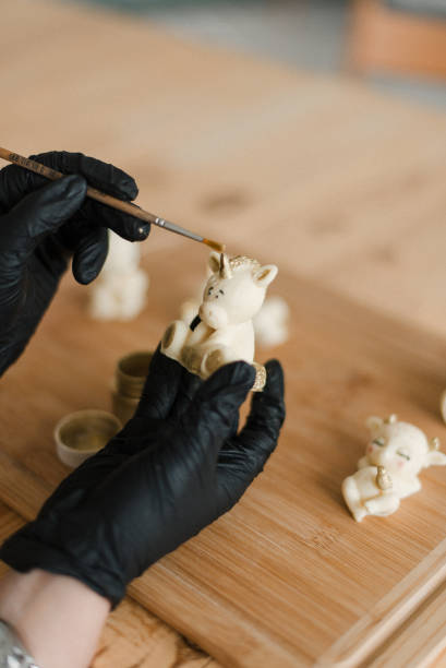 istock confectioner in gloves on the table makes edible animals 1306153640