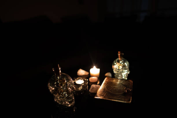istock Decoration with esoteric book surrounded by glass Skull 1306157174